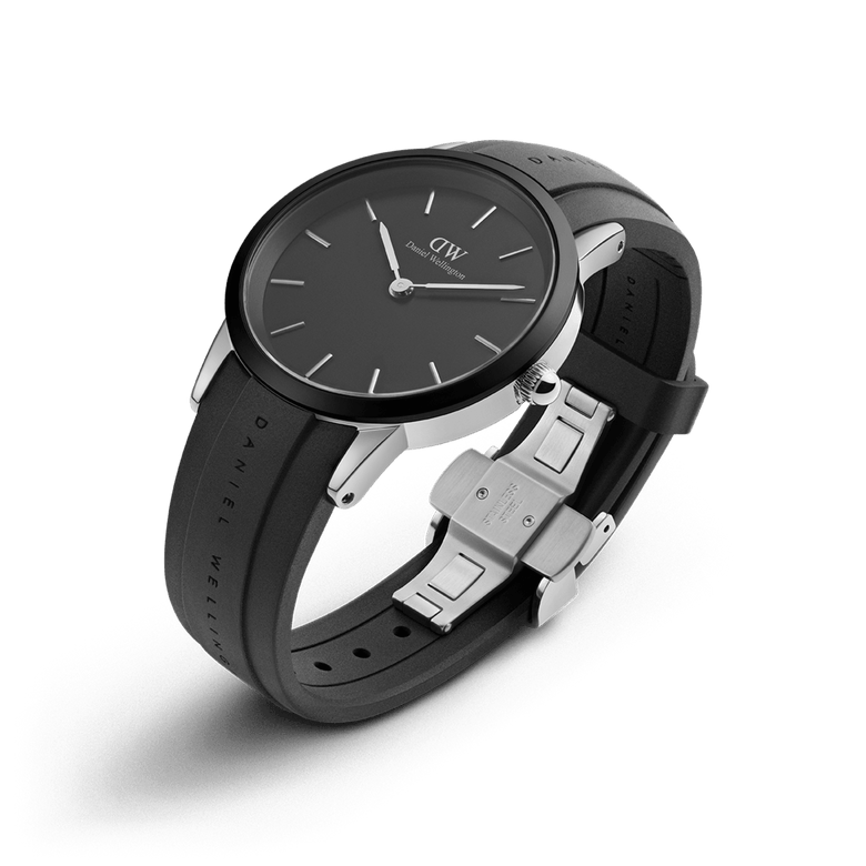 Iconic Motion Silver watch by Daniel Wellington with a minimalist black dial, silver stainless steel case, and a robust black FKM rubber strap featuring an adjustable clasp, ideal for both active and professional settings.