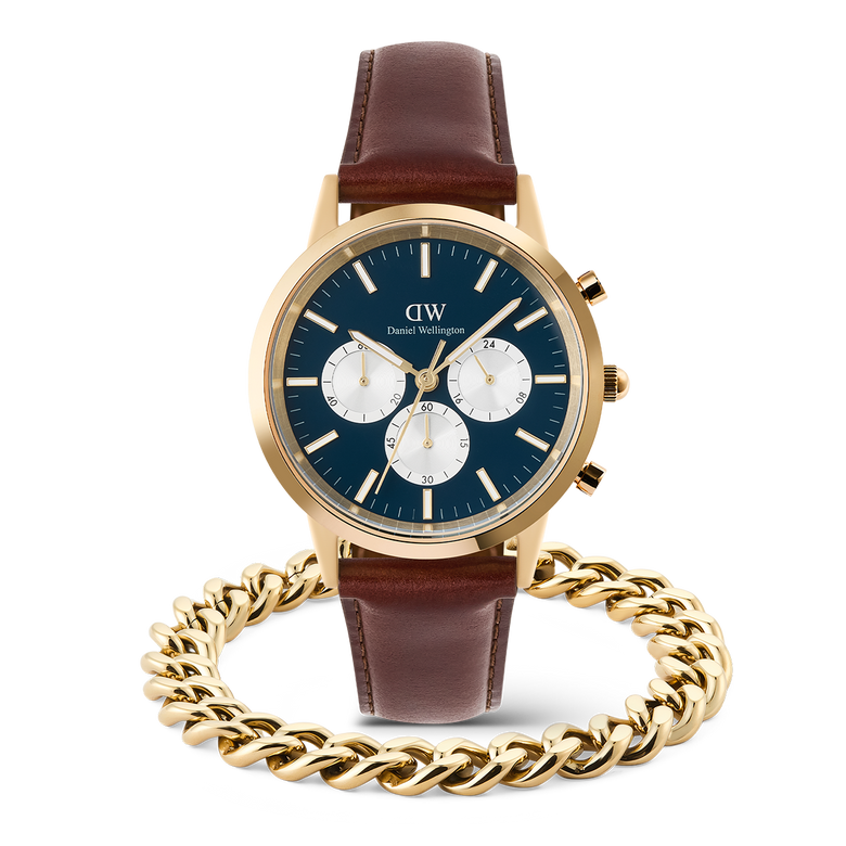 Daniel Wellington Iconic Chronograph Panda watch with a blue dial, gold accents, and brown leather strap, paired with a gold Ellipse Cuban Chain Bracelet for men.