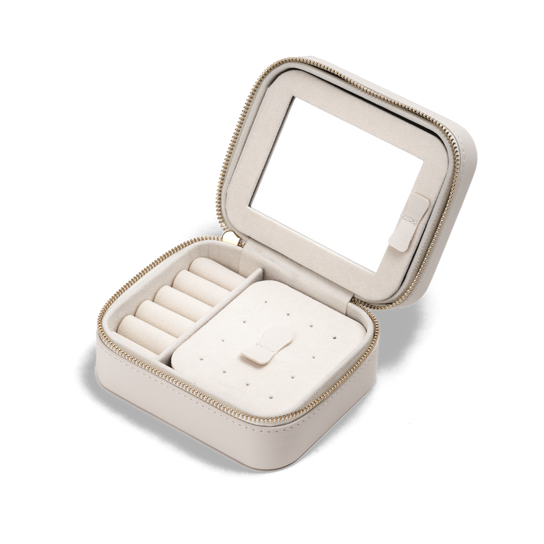 Travel Jewellery Box White with a soft white exterior, gold zip, and plush interior, featuring ring rolls, compartments for earrings and necklaces, a pouch pocket, and a built-in mirror for organised jewellery storage on the go.