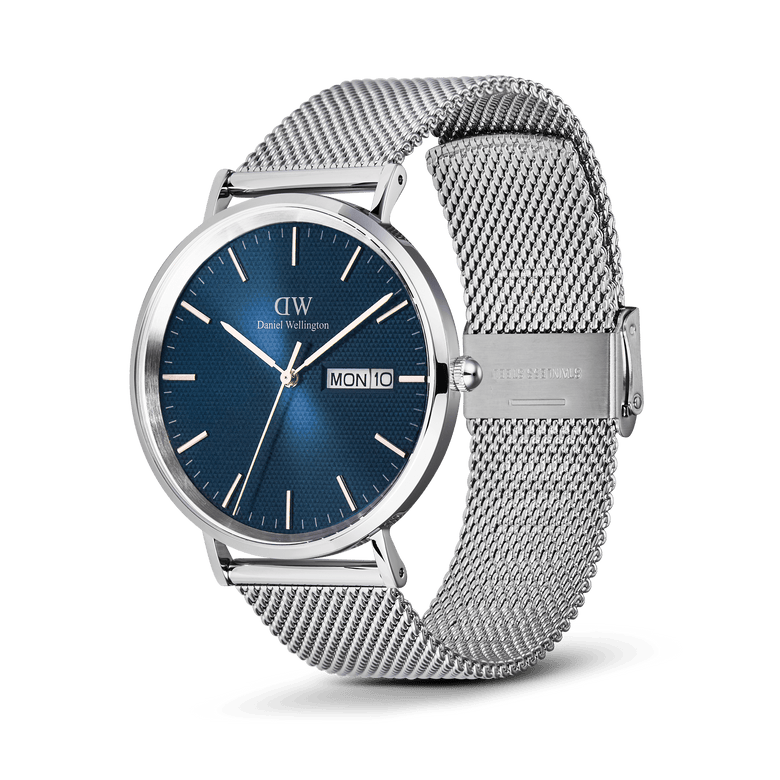 Classic Day Display Sterling Arctic men's watch with a blue dial featuring a triangle pattern, day and date window, and a stainless steel mesh strap with a safety clasp.