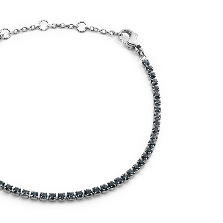 Close-up of the Classic Tennis Bracelet Nightfall Silver, highlighting its row of deep, dark Preciosa crystals set in polished silver with an adjustable chain and secure lobster clasp.
