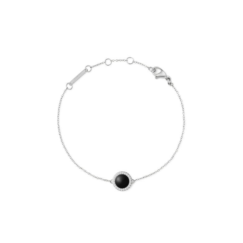 A delicate silver bracelet featuring a slim adjustable chain and a round black agate centrepiece framed by sparkling white cubic zirconia, designed for a refined and timeless look.