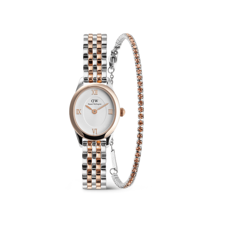 Ophelia Mini & Tennis Bracelet Apricot Silver Set featuring a petite oval watch with a two-tone silver and rose gold strap, paired with a slim tennis bracelet adorned with apricot-coloured crystals.