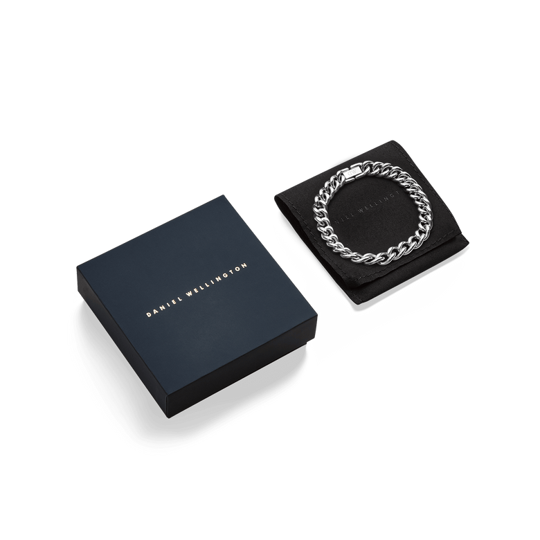 Chunky Chain Bracelet Silver displayed on a black pouch next to a sleek Daniel Wellington gift box, highlighting its polished stainless steel links and elegant presentation for gifting.