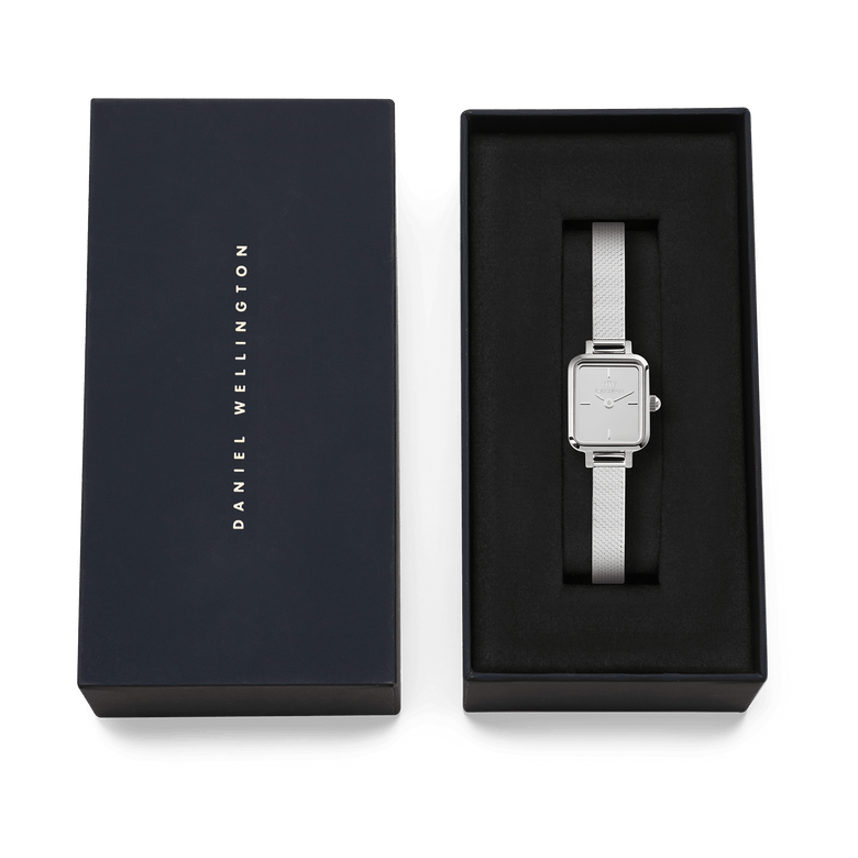 Quadro Mini Reflection Silver watch with a slim rectangular case and polished mesh strap, presented in an elegant Daniel Wellington gift box, ideal for gifting or adding to your collection.