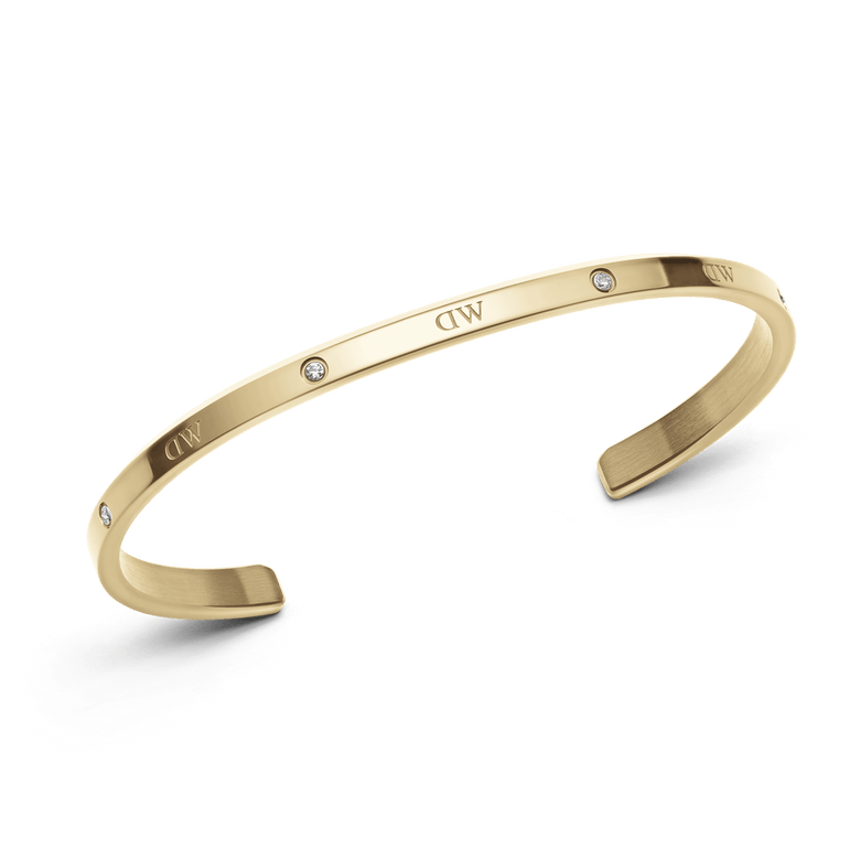 Classic Lumine Bracelet G featuring a slim, polished gold cuff with six sparkling crystals and an open design, crafted for comfortable everyday wear and elegant styling.