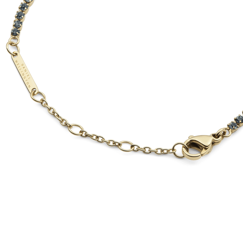 Detailed view of the Classic Tennis Bracelet Nightfall Gold, highlighting the gold chain, lobster clasp, sizing rings, and individually set deep-coloured Preciosa crystals.