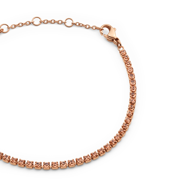 Close-up of the Classic Tennis Bracelet Apricot Rose Gold, featuring a row of apricot-coloured crystals set in rose gold with an adjustable chain and secure lobster clasp.