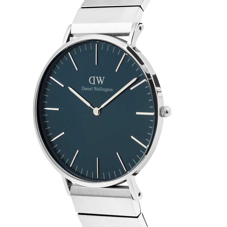 Classic Piano Link Arctic Silver watch with a brushed arctic blue dial, slim silver case, and geometric stainless steel piano link strap, shown from a side angle to highlight its minimalist design and polished finish.