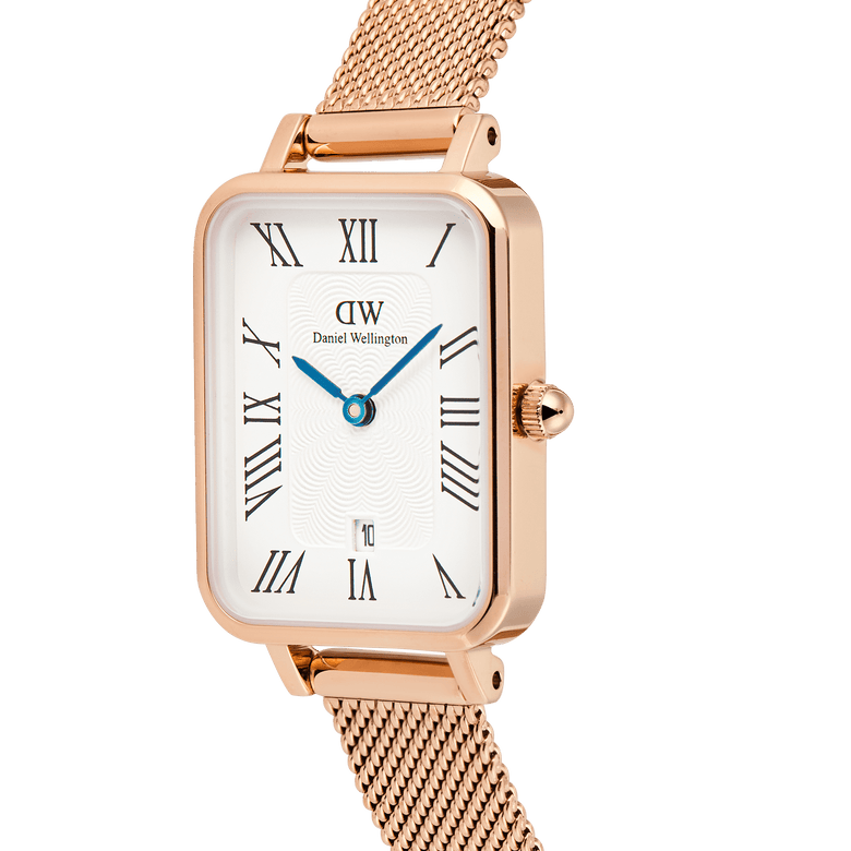 Quadro Melrose Roman Numerals Date watch featuring a rose gold rectangular case, white dial with Roman numerals, blue hands, and a rose gold mesh strap, shown in close-up to highlight its elegant details.
