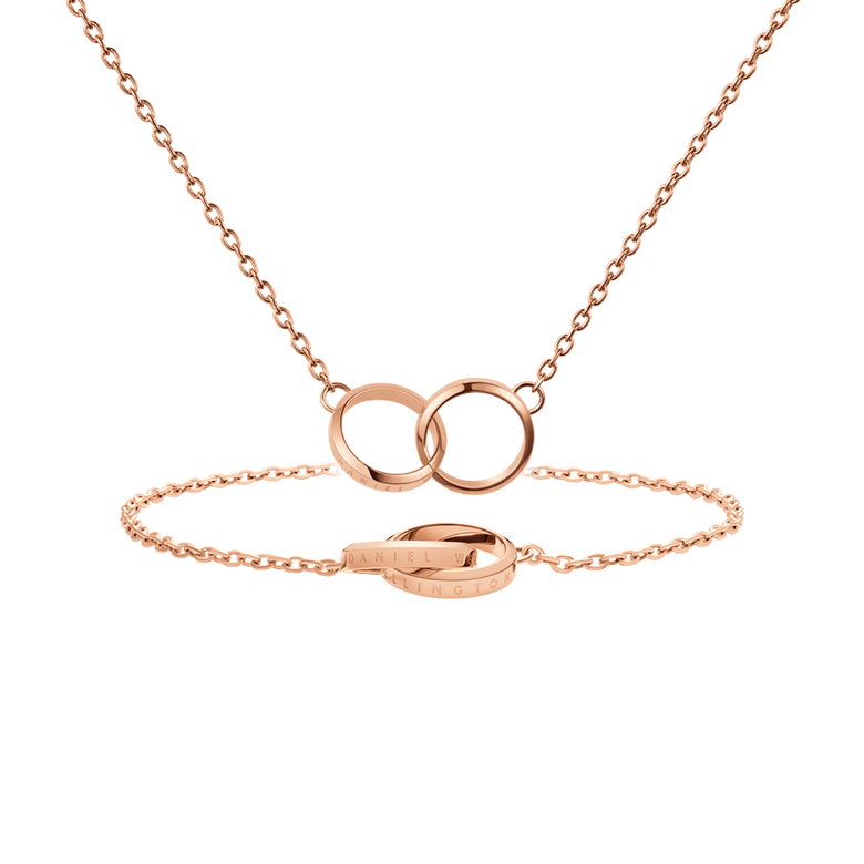 Rose gold bracelet and necklace set featuring interlocking circle motifs, crafted in a minimalist style with subtle engraved branding, ideal for layering or gifting.