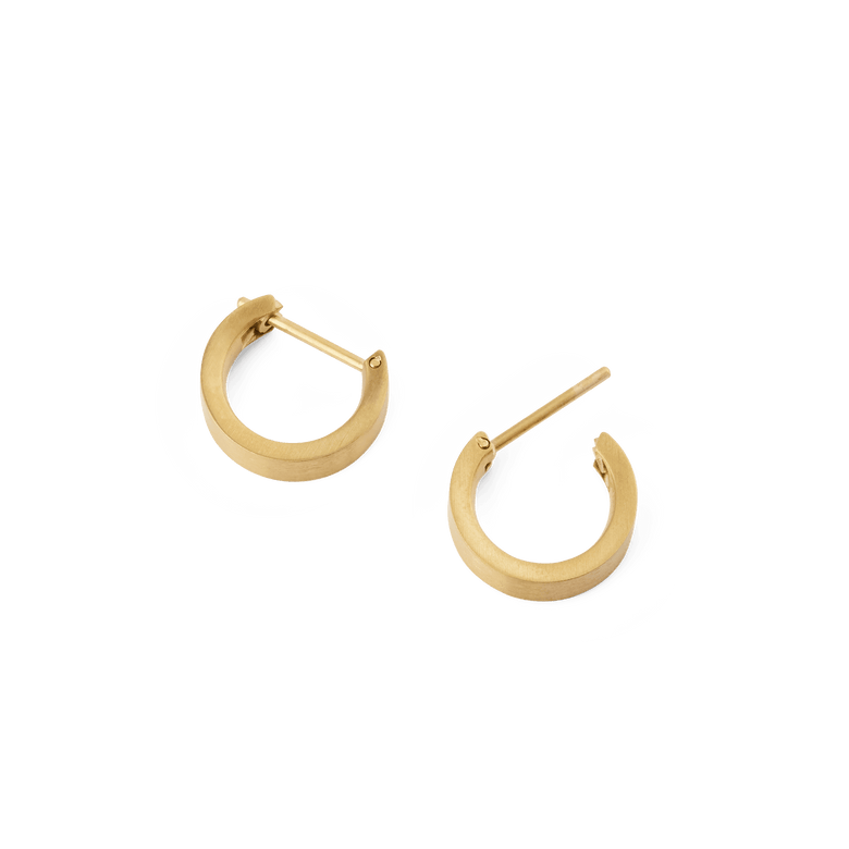 A pair of Line Earrings Brushed Gold 3.5mm shown open, highlighting their compact hoop design, softly brushed gold finish, and secure latch-back posts.