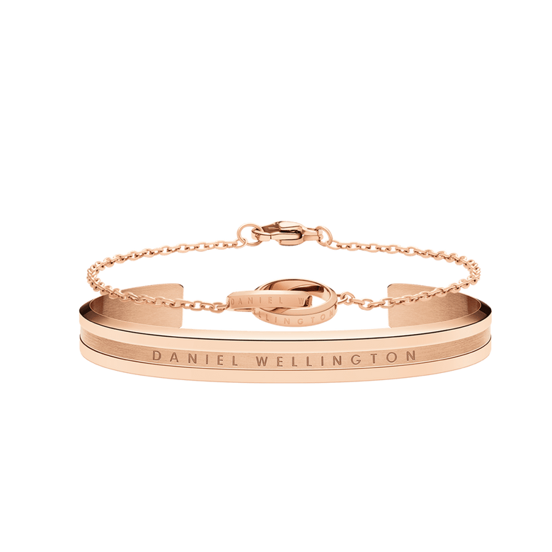 Rose gold bracelet set featuring a sleek cuff with engraved branding and a delicate chain bracelet with interlocking rings, both designed for a minimalist and elegant look.