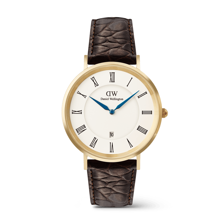 Classic men’s watch with a gold PVD-plated case, white dial featuring black Roman numerals, blue hands, and a date display, paired with a dark brown crocodile-embossed leather strap.