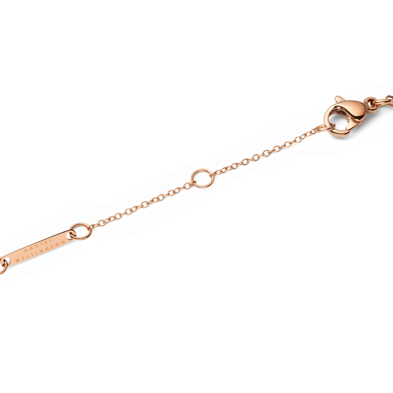 Detail of the Audrey Necklace Malachite Rose Gold adjustable chain, showing the secure lobster clasp and branded tag in a polished rose gold finish.