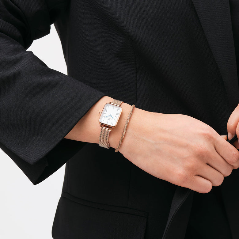 Tide Mesh Bracelet Melrose 2.8 in rose gold worn alongside a matching mesh watch, styled with a black blazer for a sophisticated and modern look.