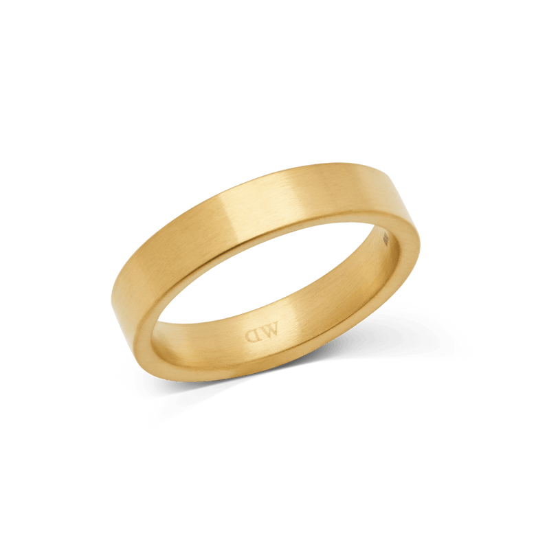 A brushed gold ring with a matte finish and minimalist design, featuring a 4.5mm width and a discreet logo on the inside band.