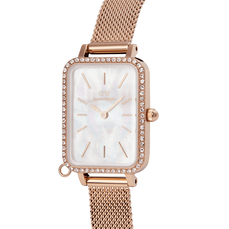 Quadro Crystal Zodiac Melrose watch featuring a slim rectangular rose gold case, crystal-studded bezel, white mother of pearl dial, and an adjustable rose gold mesh strap.