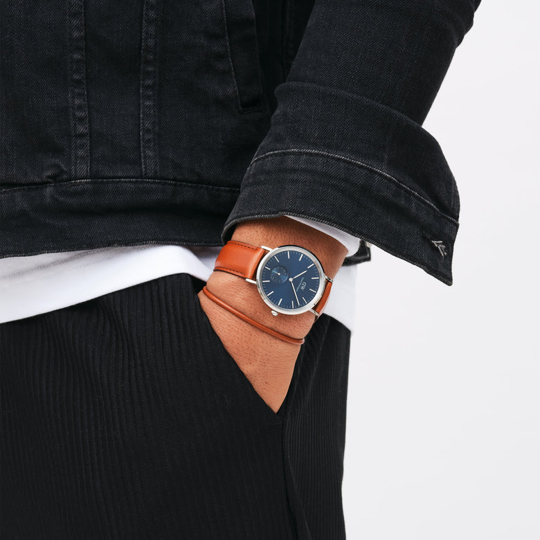 Classic Multi-Eye St Mawes Arctic Silver men's watch with a deep blue dial and brown leather strap, worn on the wrist with casual black and white clothing, highlighting its versatile and stylish design for everyday wear.