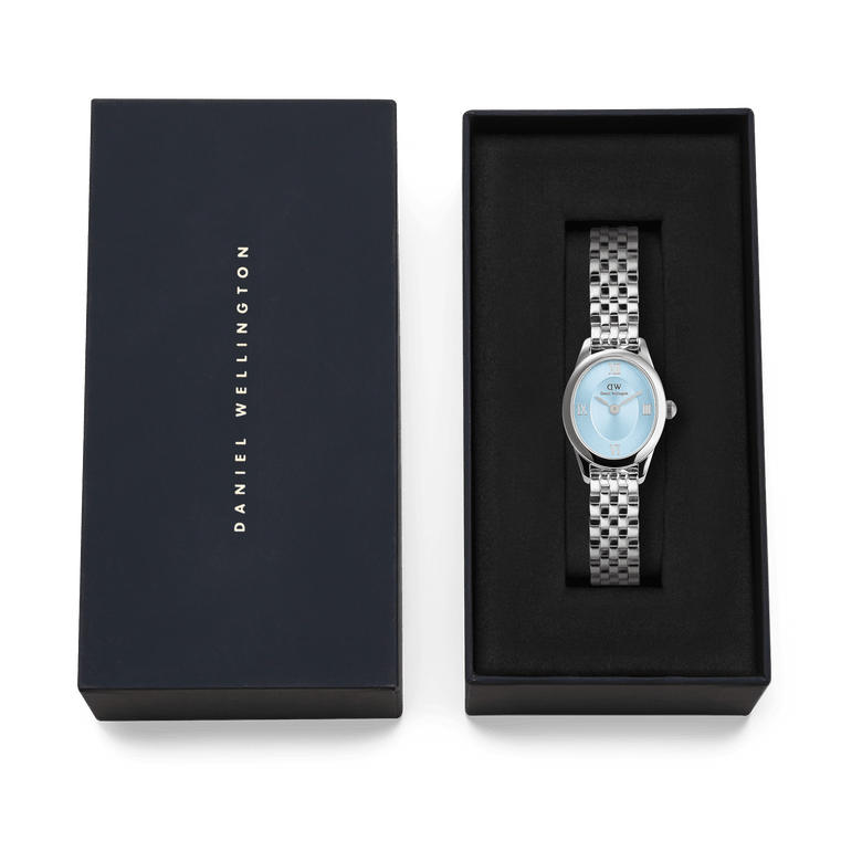 Ophelia Mini Ice Blue Silver watch with a polished stainless steel bracelet and ice blue dial, presented in a black Daniel Wellington gift box, ideal for gifting or special occasions.