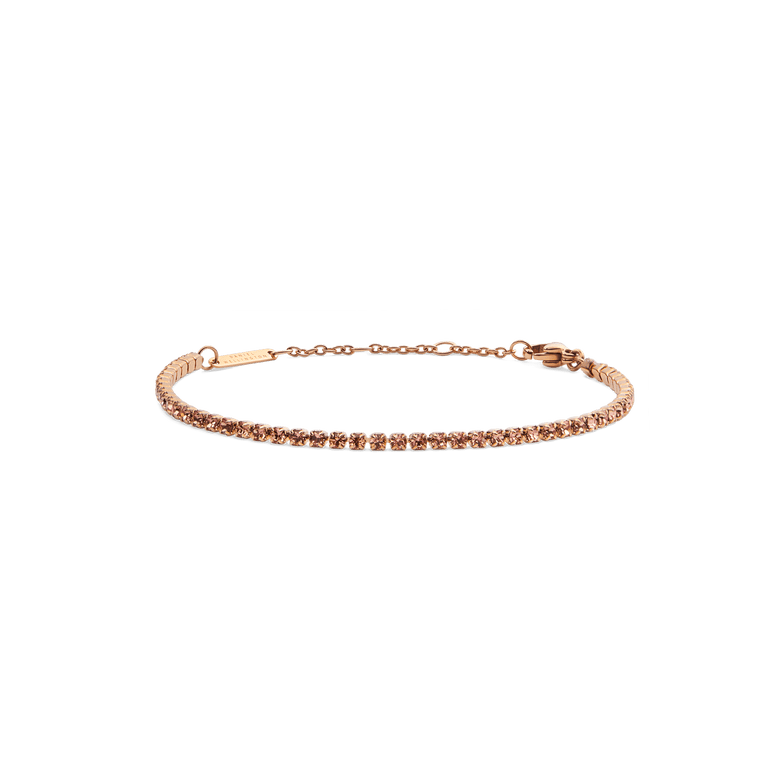 Slim rose gold tennis bracelet featuring apricot-coloured crystals, adjustable chain and lobster clasp, designed for a refined and modern look.