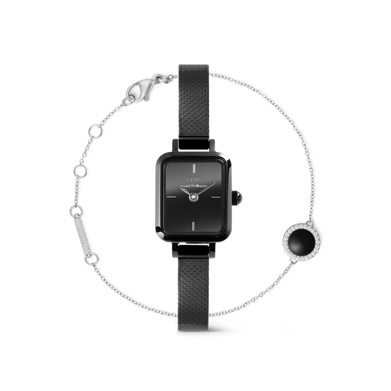 Rectangular black Daniel Wellington Quadro Mini watch with a slim black mesh strap, paired with a delicate silver Audrey Black bracelet featuring a round black stone pendant framed by sparkling details.