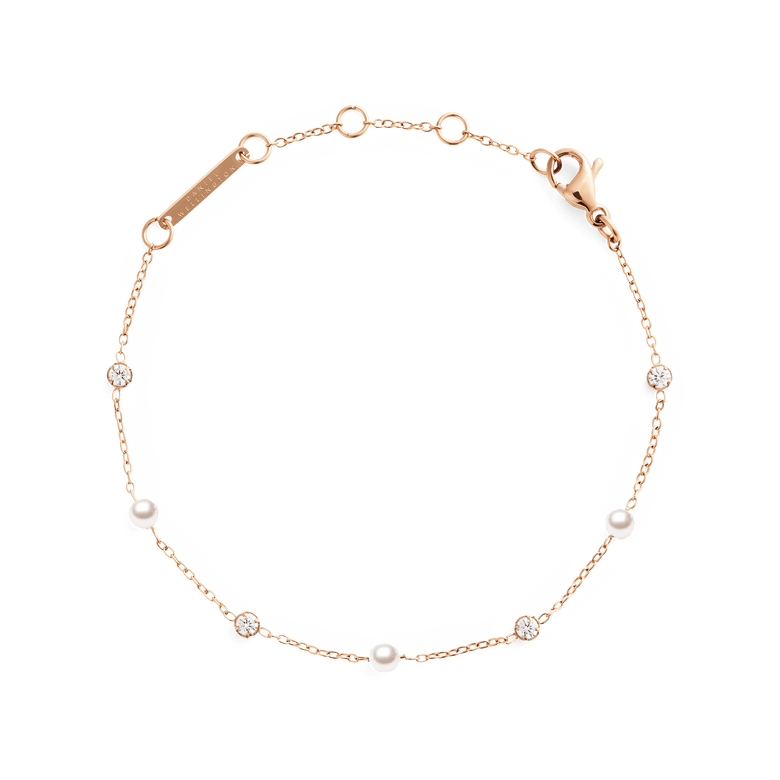 Delicate rose gold bracelet featuring alternating Swarovski glass pearls and cubic zirconia stones on a fine chain, designed with an adjustable clasp for a comfortable fit.