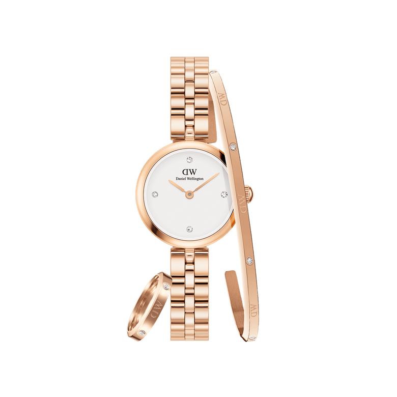 Rose gold Daniel Wellington watch with a white dial and crystal hour markers, paired with a matching rose gold bracelet and ring, both featuring delicate crystal accents for a coordinated, elegant jewellery set.