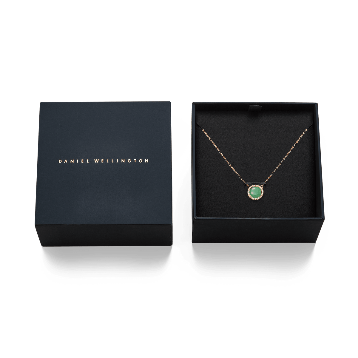 Audrey Necklace Jade Rose Gold presented in a Daniel Wellington gift box, featuring a rose gold chain and a round green jade pendant surrounded by white cubic zirconia crystals.