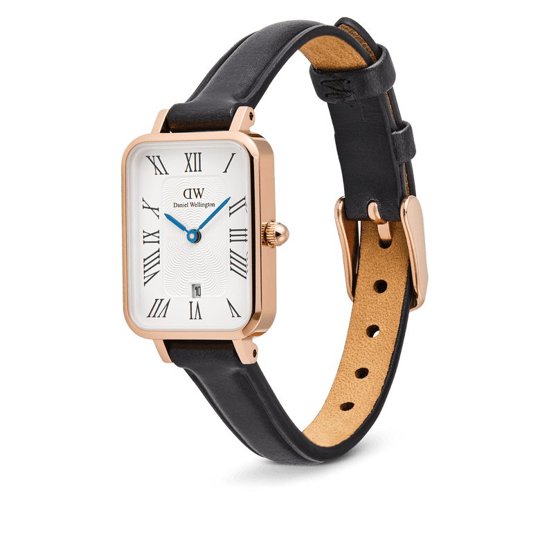 Quadro Roman Numerals Date Sheffield Rose Gold ladies watch with a rectangular rose gold case, white dial featuring Roman numerals and blue hands, date window at six o’clock, and a slim black genuine leather strap with pin buckle.