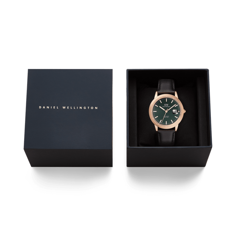 Daniel Wellington Iconic Sheffield Automatic Rose Gold watch with a green enamel dial and black leather strap, presented in an elegant branded gift box.