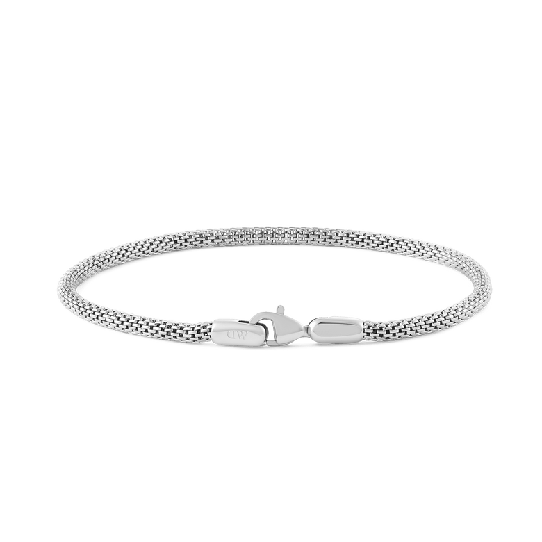 Slim silver mesh bracelet with a lobster clasp, featuring a minimalist design and a refined sterling finish suitable for both men and women.