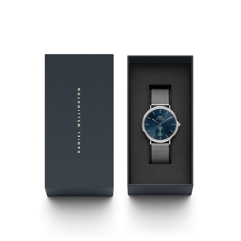 Classic Multi-Eye Sterling Arctic men's watch with a deep blue dial and silver mesh strap, presented in a sleek Daniel Wellington gift box, ideal for gifting or special occasions.