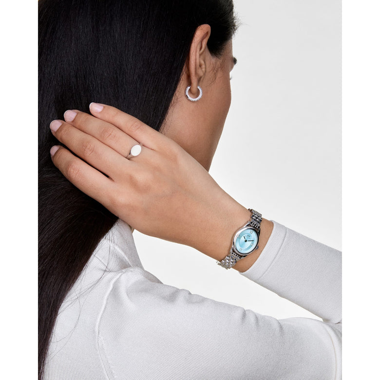 Pavé Crystal Earrings Silver worn with a silver watch and ring, highlighting the sparkling cubic zirconia hoop design and versatile styling for everyday or formal outfits.