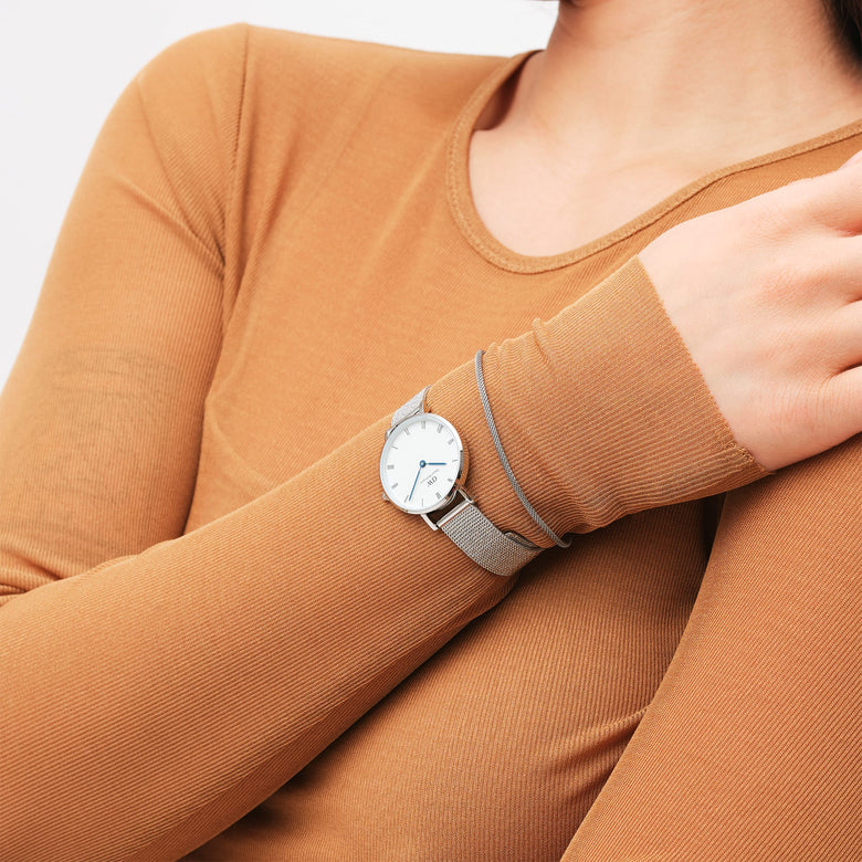 A woman wearing the Tide Mesh Bracelet Sterling 1.8 alongside a silver mesh watch, showing the slim, adjustable bracelet’s refined style and comfortable fit for everyday wear.