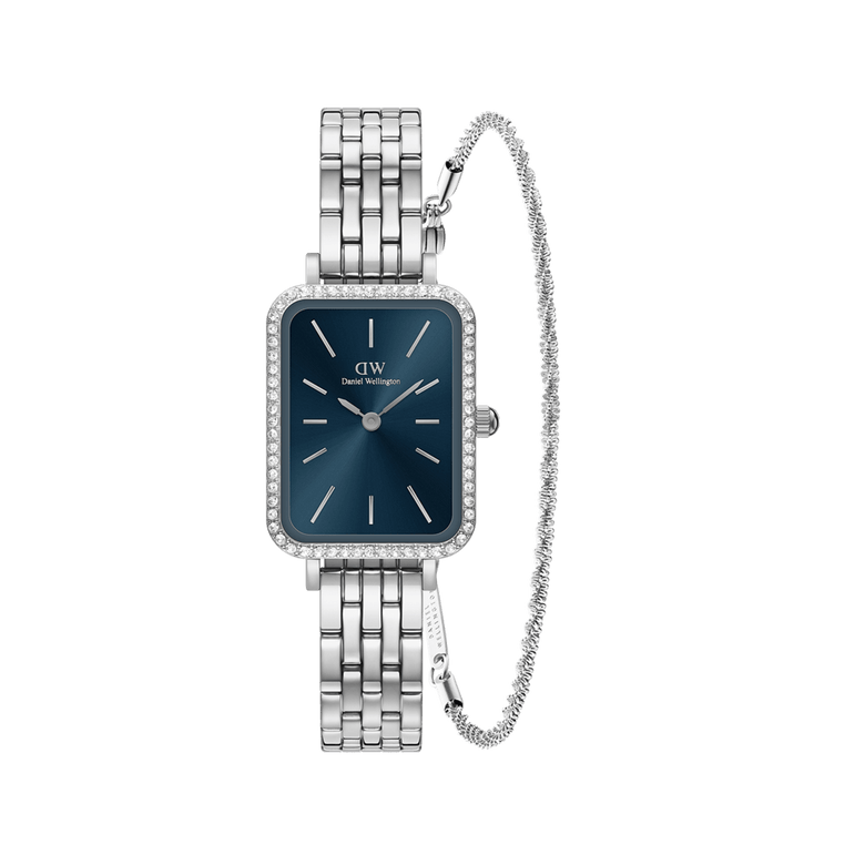 Rectangular ladies watch with a blue dial, crystal-studded bezel, and polished silver steel link strap, paired with a delicate twisted silver bracelet featuring subtle crystal accents.