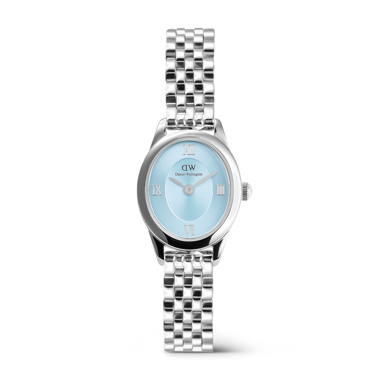 Ophelia Mini Ice Blue Silver women’s watch featuring a petite oval case, polished silver 5-link bracelet, and an ice blue sunray dial with Roman numerals, blending modern elegance with a timeless design.