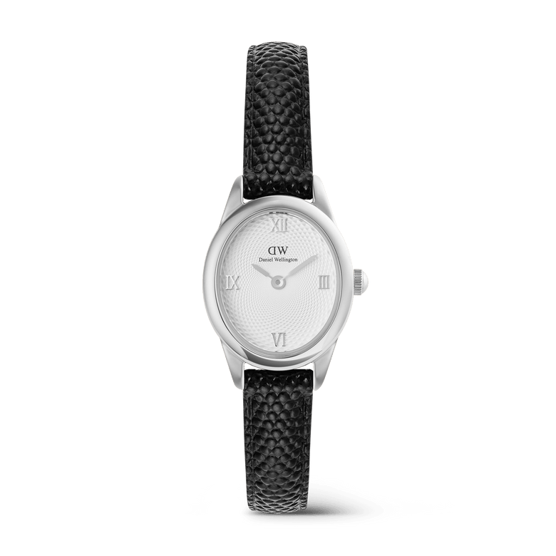 Petite ladies watch with a polished silver oval case, white guilloché dial featuring Roman numerals, and a textured black lizard-embossed leather strap.