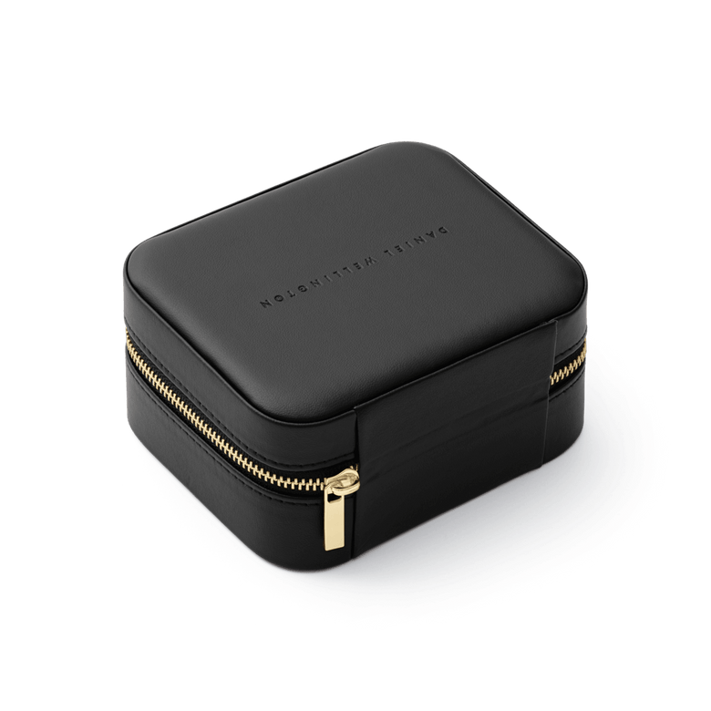 Travel Jewellery Box Black by Daniel Wellington with a refined black exterior, gold zip closure, and embossed branding, designed for stylish and secure storage of jewellery and accessories.