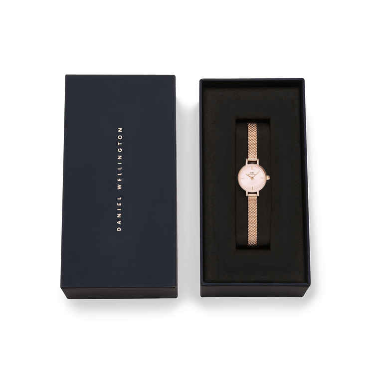 Petite Mini Blush Melrose watch with a blush pink dial and rose gold mesh strap, presented in a sleek Daniel Wellington gift box.
