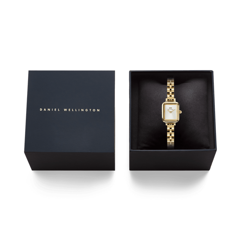 Quadro Mini Arch 3-link White Sunray Gold ladies watch presented in a black Daniel Wellington gift box, highlighting its gold rectangular case, white sunray dial, and polished 3-link bracelet.