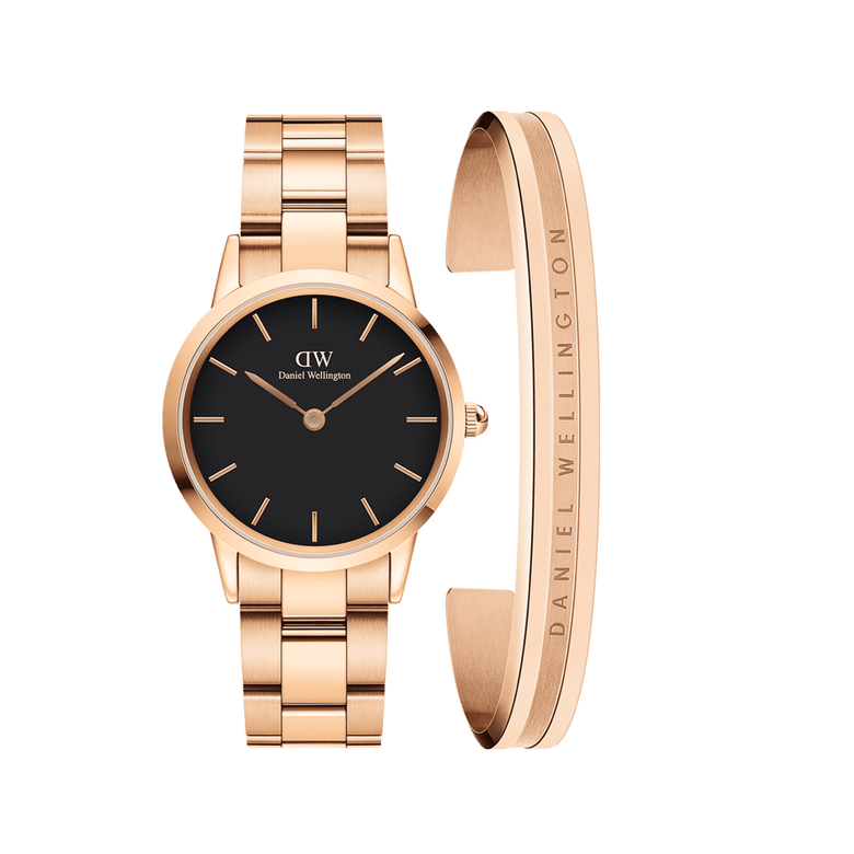 Rose gold Daniel Wellington Iconic Link Black watch with a black dial and matching rose gold link strap, paired with a minimalist rose gold Elan Bracelet featuring subtle engraved branding.