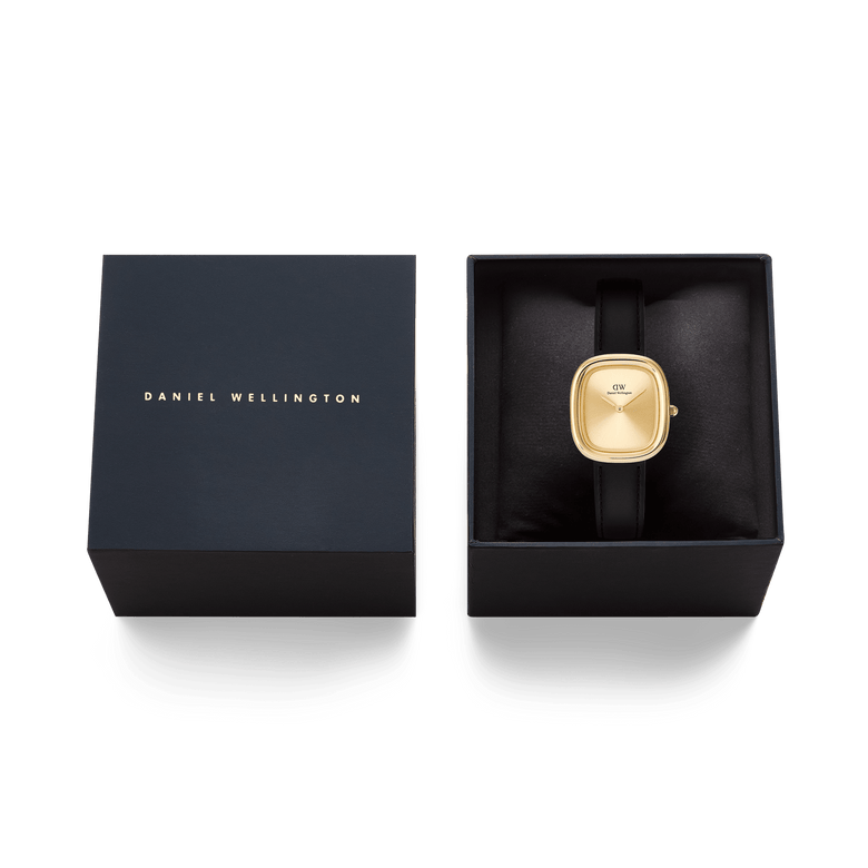 Margot Sheffield Unitone Sunray Gold ladies watch with a rectangular gold case and black leather strap, presented in a Daniel Wellington gift box.