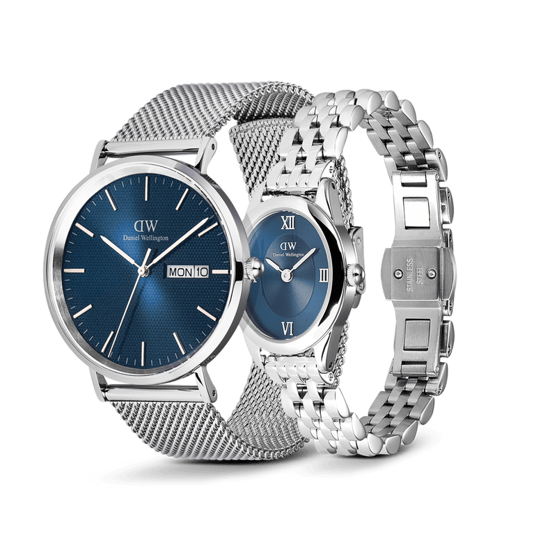 Classic Day & Ophelia Mini Arctic Silver Set featuring a men’s watch with a textured blue dial, day display, and silver mesh strap, paired with an elegant oval women’s watch with a blue dial, Roman numerals, and a polished silver link bracelet.
