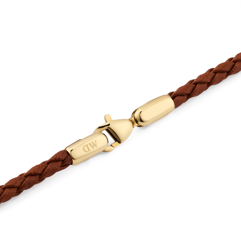 Detail of the Daniel Braided Leather Bracelet St Mawes 2.8 Gold, highlighting the gold-tone stainless steel lobster clasp and the slim, braided brown leather.