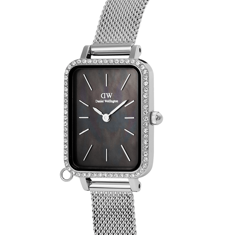 Close-up of the Daniel Wellington Quadro Crystal Zodiac Sterling Set, highlighting the rectangular silver case with crystal bezel, black mother of pearl dial, and sleek silver mesh strap.