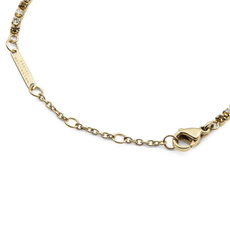 Detail view of the Classic Tennis Bracelet Honey Combo Gold, highlighting the adjustable sizing rings, lobster clasp, and gold chain with individually set honey and clear crystals.