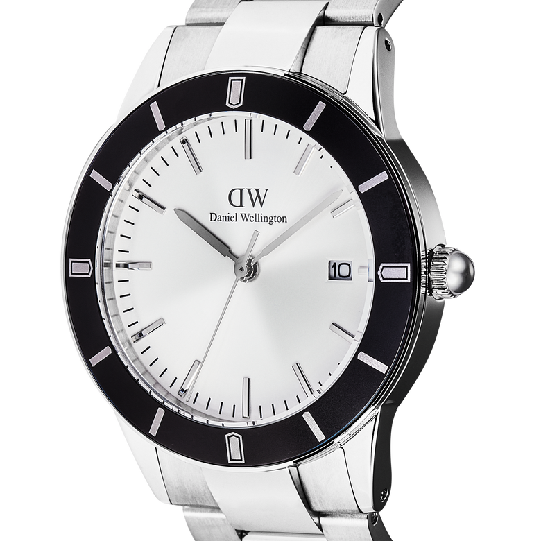 Close-up of the Daniel Wellington Iconic Paradigma Link Black Bezel watch, highlighting its silver dial, bold black bezel with printed index markings, and stainless steel bracelet with polished and brushed links.