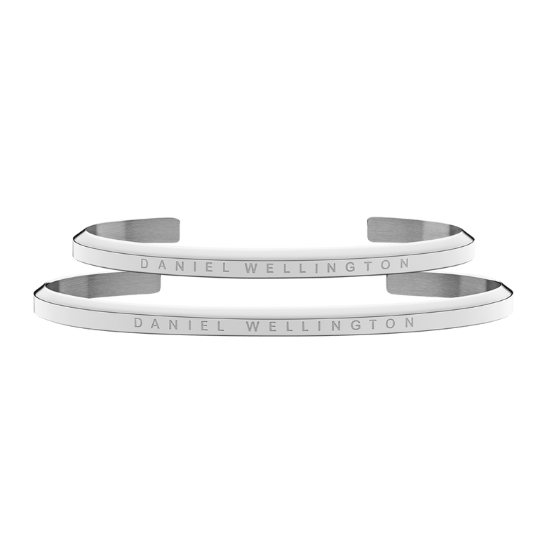 Two slim, polished silver cuff bracelets with the Daniel Wellington logo engraved along the surface, featuring a minimalist and refined design suitable for both men and women.