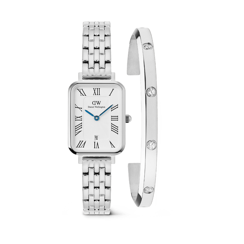 Rectangular silver ladies watch with a five-link stainless steel strap, Roman numeral dial, and blue hands, paired with a sleek silver cuff bracelet featuring sparkling crystal accents.